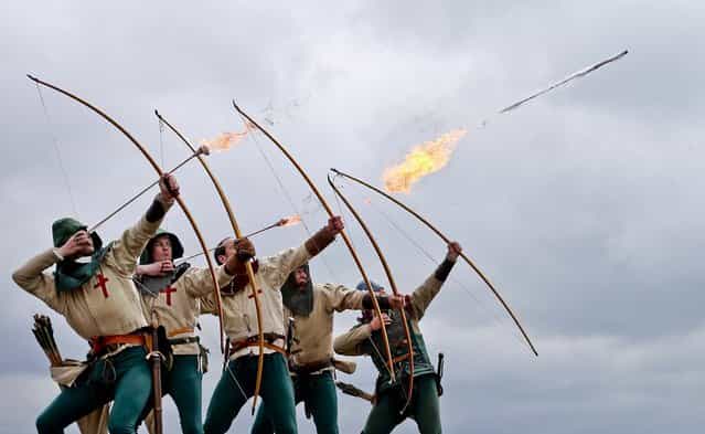 Purbrook Bowmen fire a volley of flaming arrows from Southsea Castle as part of a day of events to mark the opening of the Mary Rose Museum in Portsmouth, England, on May 30, 2013. (Photo by Peter Macdiarmid/Getty Images)
