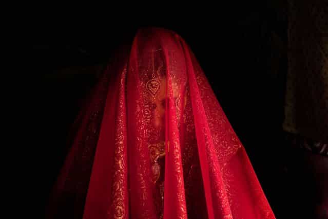 Zareena, a Kashmiri Bakarwal bride, sits inside a temporary camp during her wedding ceremony on the outskirts of Srinagar, India, on May 31, 2013. (Photo by Dar Yasin/Associated Press)