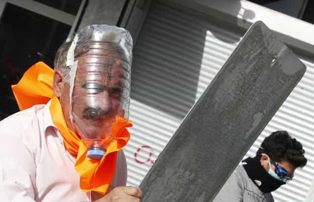 A demonstrator wears a gas mask made out of a plastic water bottle during a protest against Turkey's Prime Minister Tayyip Erdogan and his ruling AK Party in central Ankara June 2, 2013. (Photo by Umit Bektas/Reuters)
