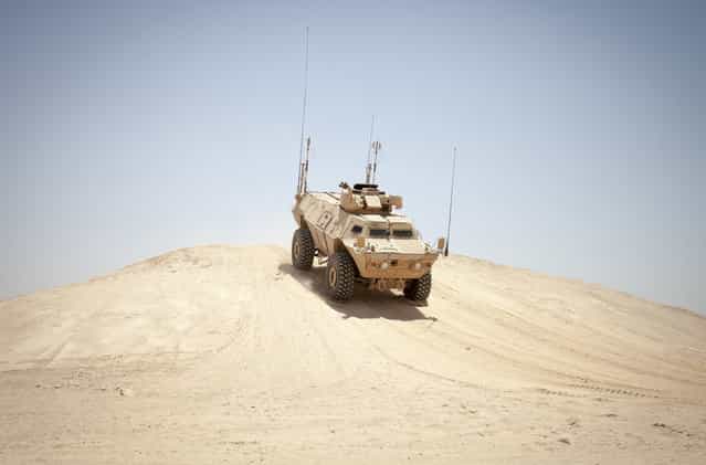 A Mobile Strike Force Vehicle assigned to the Afghan National Army Mobile Strike Force Kandak, navigates through a series of obstacles at a rough terrain driving course on Camp Bastion, Helmand province, on May 13, 2013. (Photo by Staff Sgt. Ezekiel R. Kitandwe/USMC)