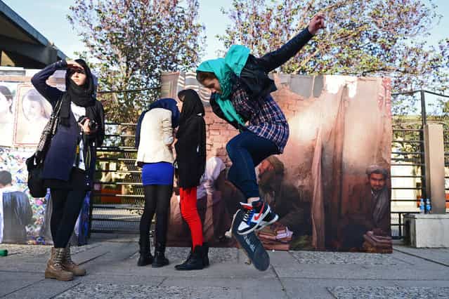 A foreign youth pops an ollie on her skateboard as Afghan youths gather for The Sound Central Festival at the French Cultural Center in Kabul, on May 2, 2013. The Sound Central Festival, now on its second year, is the only event of its kind that takes places in Afghanistan, where music was banned by the Taliban until the end of 2001. (Photo by Massoud Hossaini/AFP Photo)