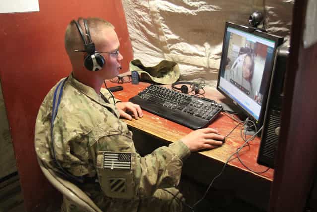 U.S. Army Spc. Robert Purvis, a generator mechanic with Headquarters Support Company, 3rd Battalion, 7th Infantry Regiment, 4th Infantry Brigade Combat Team, 3rd Infantry Division, skypes with his wife Shandel Purvis, on May 13, 2013, from Forward Operating Base Shank, Afghanistan, as they wait for the birth of their first son at Winn Army Community Hospital, Fort Stewart, Georgia. (Photo by Staff Sgt. Elvis Umanzor/US Army)
