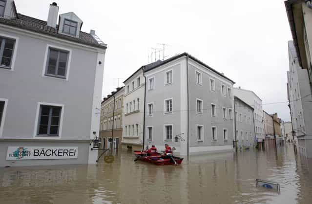 Members of the emergency services travel by boat along flooded streets in the centre of the Bavarian town of Passau, about 200 km (124 miles) north-east of Munich June 3, 2013. Torrential rain in the south and south-east of Germany caused heavy flooding over the weekend, forcing people to evacuate their homes. (Photo by Michaela Rehle/Reuters)