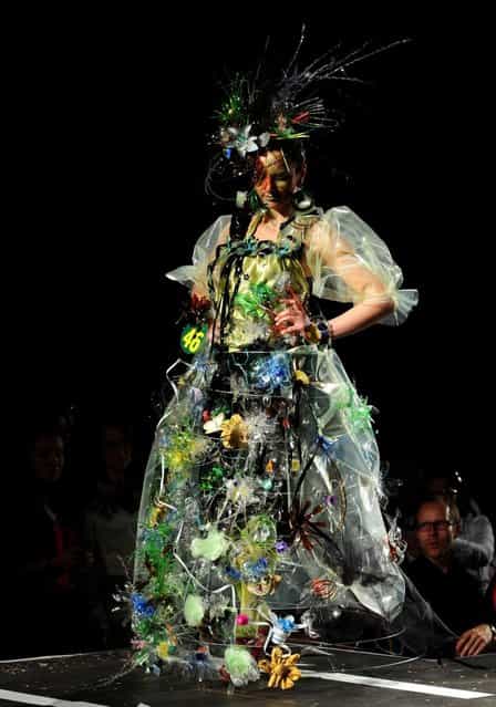 A model presents a creation during Trash Fashion Show in Macedonia's capital Skopje, on Wednesday, June 5, 2013. Teams from 47 high schools from Macedonia participated in the show with creations made of redesigned materials from waste such as plastic bags, newspapers, cardboard, plastic bottles, cans, used paper, etc. (Photo by Boris Grdanoski/AP Photo)