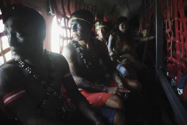 Munduruku Indians, many flying for the first time, ride in a Brazilian Air Force plane as they are transported to Brasilia for talks with the government, June 4, 2013. Air Force planes flew 144 Munduruku Indians to Brasilia for talks to end a week-long occupation of the controversial Belo Monte dam on the Xingu River, a huge project aimed at feeding Brazil's fast-growing demand for electricity. (Photo by Ueslei Marcelino/Reuters)