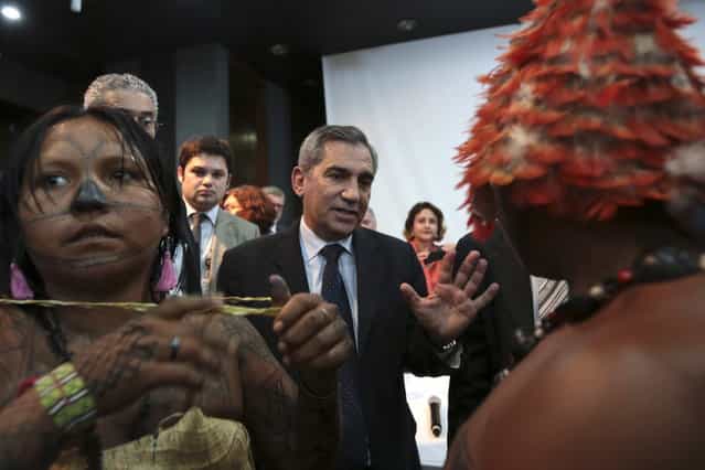 Minister of the General Secretariat of the Presidency of Brazil Gilberto Carvalho speaks with Munduruku Indians during a meeting at the Planalto Palace to try to resolve the occupation of the construction of Belo Monte, in Brasilia June 4, 2013. President Dilma Rousseff's government sought on Tuesday to defuse mounting conflicts with indigenous groups over its decision to stop setting aside farm land for Indians and plans to build more hydroelectric dams in the Amazon. (Photo by Ueslei Marcelino/Reuters)