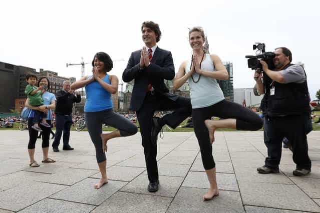 Liberal leader Justin Trudeau (C) poses with yoga enthusiasts following a news conference on Parliament Hill in Ottawa June 5, 2013. (Photo by Chris Wattie/Reuters)