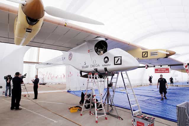 Solar Impulse, a solar-powered airplane with a wingspan of 208 ft, similar to a Boeing 747, is parked in its inflatable hangar at Lambert-St. Louis International Airport on Tuesday, June 4, 2013, in St. Louis. The airplane, which can fly day and night without fuel, uses solar power gathered from 11,628 silicon solar cells mounted on the wing and horizontal stabilizer to power four electric engines. Piloted by Bertrand Piccard and Andre Borschberg, the Solar Impulse is on a journey across America. (Photo by St. Louis Post-Dispatch, Erik M. Lunsford/AP Photo)