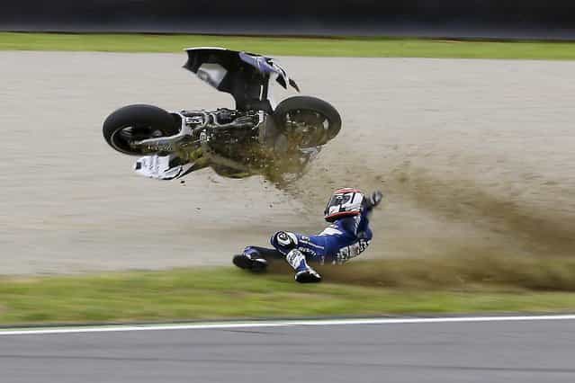 France's Randy De Puniet crashes during a free practice session for Sunday's Italian Moto GP, at the Mugello race circuit, in Scarperia, Italy, Saturday, June 1, 2013. (Photo by Antonio Calanni/AP Photo)