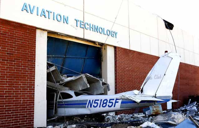 An airplane is damaged in the Aviation Technology building on the campus of the Canadian Valley Technology Center in El Reno, Oklahoma, on June 2, 2013, after a massive tornado roared through the area on Friday causing widespread damage and flooding. (Photo by Alonzo Adams/Associated Press)