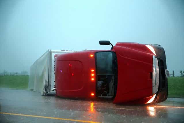 An overturned semitrailer rests on its side on the eastbound lanes of Interstate 40, just east of El Reno, Okla., after a reported tornado touched down, Friday, May 31, 2013. (Photo by Chris Machian/AP Photo/Omaha World-Herald)