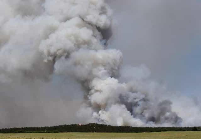 A fire burns out of control north of Shoupe Road and East of Highway 83 in Colorado Springs, Colo. on Tuesday afternoon, June 11, 2013. (Photo by Christian Murdock/AP Photo/The Colorado Springs Gazette)