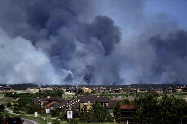 Large plumes of smoke rise from a wild land fire in the Black Forest northeast of Colorado Springs, Colo. on Tuesday, June 11, 2013. Homes have already burned and the wind is expected to continue through the afternoon. (Photo by Aaron Ontiveroz/AP Photo/The Denver Post)