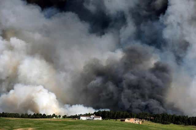 Large plumes of smoke rise from a wild land fire in the Black Forest northeast of Colorado Springs, Colo. on Tuesday, June 11, 2013. Homes have already burned and the wind is expected to continue through the afternoon. (Photo by Helen H. Richardson/AP Photo/The Denver Post)