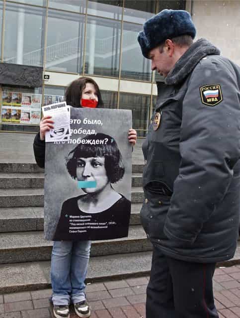 A gay rights activist holds a board displaying 19th century Russian poet Marina Tsvetaeva during an unsanctioned protest rally to defend the rights of Russian gays and lesbians in St. Petersburg, in this April 7, 2012 file photo. Along with a planned new law banning the spread of gay [propaganda] among minors, President Vladimir Putin has also overseen a religious revival that aims to give the Orthodox Church, whose leader has suggested that homosexuality is one of the main threats to Russia, a more public role as a moral authority. The number of documented cases of violence against gays in Russia is low. But there are no official figures on anti-gay crime in Russia, and gay rights campaigners say the numbers available mask the true number of attacks on gays, lesbians, bisexual and transgender people. Most go unreported, or are not classified as such by the police. (Photo by Alexander Demianchuk/Reuters)