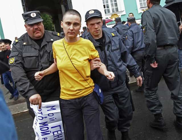 Police detain a gay rights activist during a protest in St. Petersburg June 26, 2010. Along with a planned new law banning the spread of gay [propaganda] among minors, President Vladimir Putin has also overseen a religious revival that aims to give the Orthodox Church, whose leader has suggested that homosexuality is one of the main threats to Russia, a more public role as a moral authority. The number of documented cases of violence against gays in Russia is low. But there are no official figures on anti-gay crime in Russia, and gay rights campaigners say the numbers available mask the true number of attacks on gays, lesbians, bisexual and transgender people. Most go unreported, or are not classified as such by the police. The poster reads: [My gender is my choice]. (Photo by Alexander Demianchuk/Reuters)