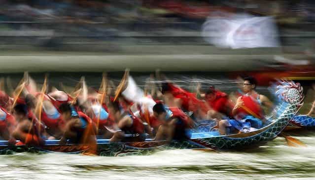 A helmsman steadily steers his boat during the annual Dragon Boat Festival races in Taipei, Taiwan. Dragon boat races are held in remembrance of Chu Yuan, an ancient Chinese scholar-statesman, who drowned in 277 B.C. while denouncing government corruption. (Photo by Wally Santana/Associated Press)