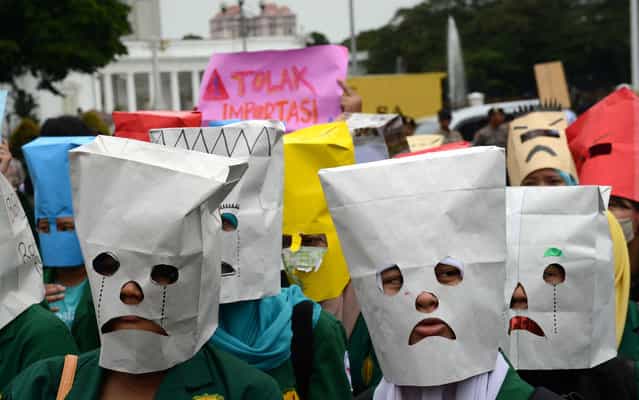 Indonesian students wear masks with angry expressions during a protest outside the presidential palace in Jakarta on June 12, 2013 to denounce impending fuel price increases, as the government plans to reduce a fuel subsidy. Indonesian President Susilo Bambang Yudhoyono said on April 30 that he hopes to lower fuel subsidies which are a risk to Southeast Asia's top economy as concern mounts over the economic damage wrought by the scheme that gobbles up more than 16 percent of the state budget. (Photo by Romeo Gacad/AFP Photo)