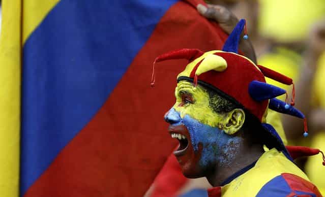A Colombian soccer fan cheers his team prior to a 2014 World Cup qualifying match against Peru in Barranquilla, Colombia, on June 11, 2013. (Photo by Ricardo Mazalan/Associated Press)