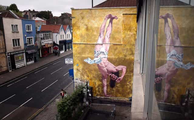 Cosmo Sarson's mural of Jesus breakdancing fills an 8.5 meter wall beside The Canteen in Bristol, England, on June 11, 2013. The mural was inspired by an actual event in the Vatican, where breakdancers performed to an applauding Pope John Paul II in 2004. The new mural [represents everything Bristol should be proud of and will remain on the wall for two years], James Pike from the Canteen told the BBC. [We have a proud history of religious tolerance, incredible cultural diversity and a vibrant creative history]. (Photo by Matt Cardy/Getty Images)