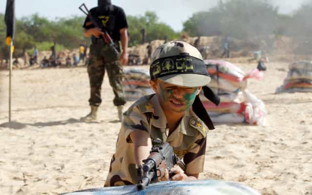 A Palestinian child in a military summer camp organized by the Islamic Jihad during the summer school holidays, on June 12, 2013. Young people aged six to 16 years in Rafah, southern Gaza Strip, receive military and religious training. (Photo by RAFAH)