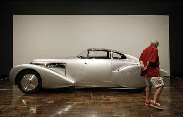 Tandy Culpepper views a 1938 Hispano-Suiza H6 Dubonnet [Xenia] Coupe on Friday, June 14, 2013, in Nashville, Tenn., as part of the [Sensuous Steel] exhibit at the Frist Center for the Visual Arts. The exhibit is made up of cars and motorcycles from the 1930s and 1940s that exemplify the elegance and styling characteristic of the Art Deco style. The exhibit is scheduled to run through September 15. (Photo by Mark Humphrey/AP Photo)
