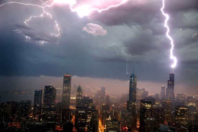 Lightning strikes the Willis Tower (formerly Sears Tower) in downtown on June 12, 2013 in Chicago, Illinois. A massive storm system with heavy rain, high winds, hail and possible tornadoes is expected to move into Illinois and much of the central part of the Midwest today. (Photo by Scott Olson/AFP Photo)