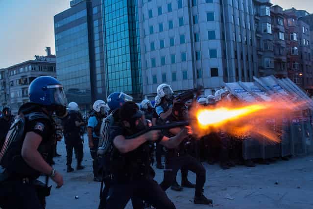 Riot police fire tear gas to disperse the crowd during a demonstration near Taksim Square on June 11, 2013 in Istanbul, Turkey. Istanbul has seen protests rage on for days, with two protesters and one police officer killed. What began as a protest over the fate of Taksim Gezi Park has turned, with the heavy-handed response by police, into a protest over what is being seen as Prime Minister Recep Tayyip Erdogan's increasingly authoritarian agenda. (Photo by Lam Yik Fei/Getty Images)