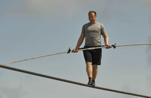 High wire walker Nik Wallenda balances on a 1,200 foot (366 meter) cable during a practice session in Sarasota, Florida, June 14, 2013. Wallenda is training for his untethered high wire walk across the Grand Canyon scheduled for June 23. (Photo by Steve Nesius/Reuters)
