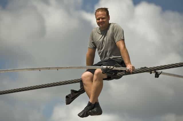 High wire walker Nik Wallenda balances on a 1,200 foot (366 meter) cable during a practice session in Sarasota, Florida, June 14, 2013. Wallenda is training for his untethered high wire walk across the Grand Canyon scheduled for June 23. (Photo by Steve Nesius/Reuters)