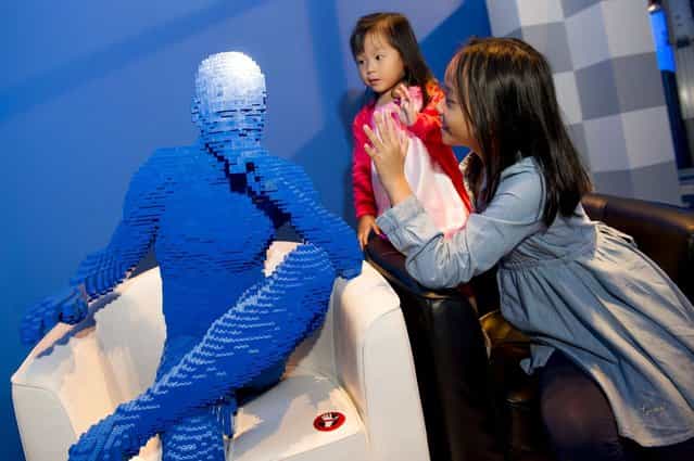 [Blue man sits in chair]. (Photo by Nathan Sawaya/The Art of the Brick)