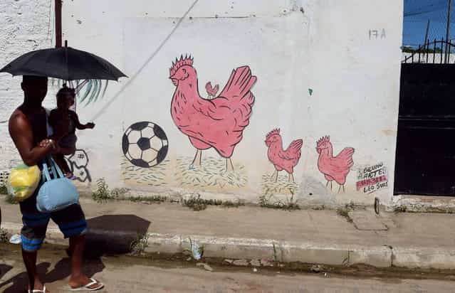 Picture of a graffiti on a wall in a shantytown of Olinda, near Recife in northeastern Brazil, taken on June 18, 2013 during the FIFA Confederations Cup Brazil 2013 football tournament. (Photo by Vincenzo Pinto/AFP Photo)