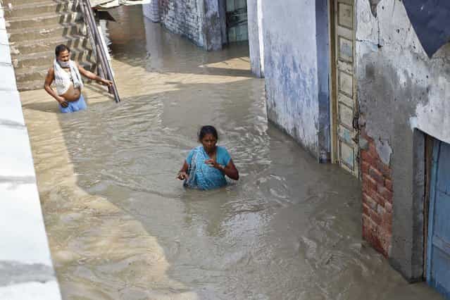 Residents wade through an alley flooded with the rising water level of river Yamuna after heavy monsoon rains in New Delhi June 19, 2013. The rains are at least twice as heavy as usual in northwest and central India as the June-September monsoon spreads north, covering the whole country a month faster than normal. (Photo by Anindito Mukherjee/Reuters)