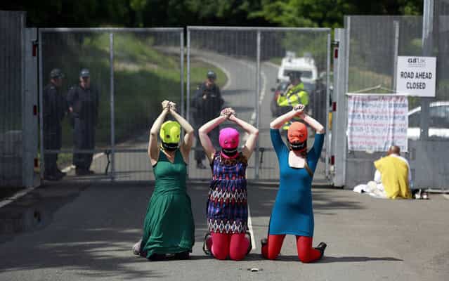 Demonstrators wear [Free Pussy Riot] balaclavas as they protest at the security fence surrounding the G8 Summit at Lough Erne in Enniskillen, Northern Ireland June 17, 2013. (Photo by Cathal McNaughton/Reuters)