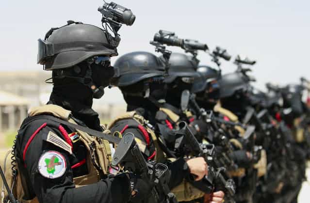 Iraqi anti-terrorism special forces stand at attention before a simulated hijacking of a plane, during a training exercise in Baghdad airport, Iraq, Wednesday, June 19, 2013. Iraqi police pe

<div class=