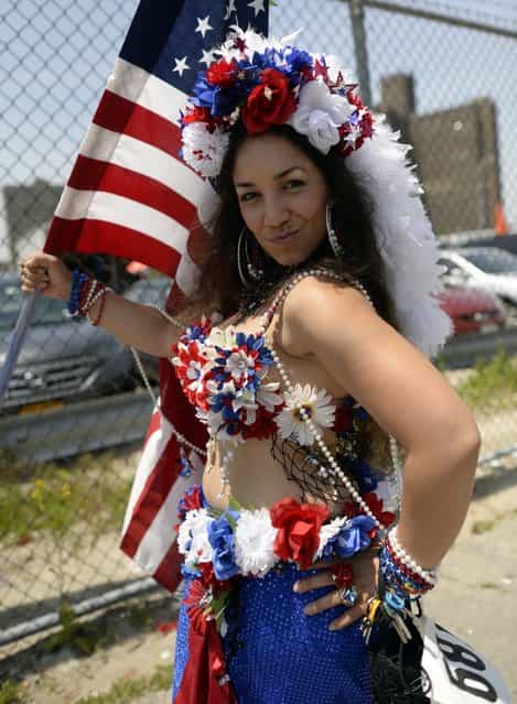 A parade participant arrives in costume for the 31st Annual Mermaid Parade at New York's Coney Island on June 22, 2103. Over 700,00 people are exptected to turn out for the scantily clad parade. AFP PHOTO / TIMOTHY CLARY (Photo credit should read TIMOTHY CLARY/AFP/Getty Images)