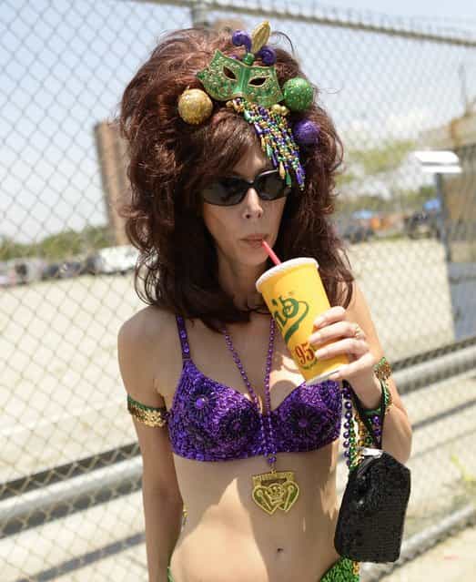 A parade participant arrives in costume for the 31st Annual Mermaid Parade at New York's Coney Island on June 22, 2103. Over 700,00 people are exptected to turn out for the scantily clad parade. (Photo by Timothy Clary/AFP Photo)