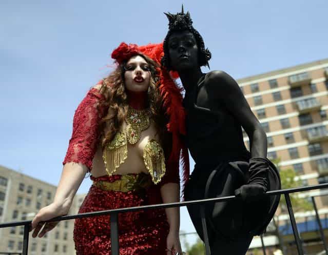 Parade participants arrive in costume for the 31st Annual Mermaid Parade at New York's Coney Island on June 22, 2103. Over 700,00 people are exptected to turn out for the scantily clad parade. AFP PHOTO / TIMOTHY CLARY (Photo credit should read TIMOTHY CLARY/AFP/Getty Images)