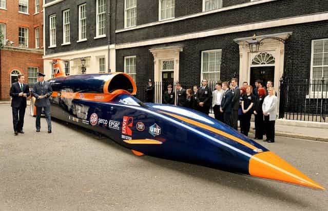 The Prime Minister David Cameron talks to RAF Pilot Andy Green about the British built Bloodhound Jet Car, that he will drive to try and smash the World land speed record of 763mph, on the day the PM announces the initiative to create 100,000 engineering jobs outside Downing Street Westminster in central London, on June 24, 2013. (Photo by John Stillwell/PA Wire)
