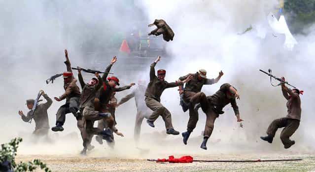 South Korean soldiers play their roles as North Koreans as they re-enact the battle of Chuncheon in Chuncheon, north of Seoul, on June 22, 2013. The country marks the 63rd anniversary of the beginning of the war on June 25. (Photo by Lee Jin-man/Associated Press)