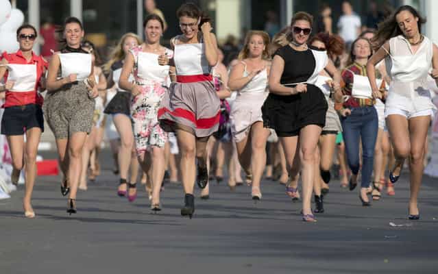 Women compete in a high heels race organized by a fashion magazine in Bucharest, Romania, Tuesday, June 25, 2013. (Photo by Vadim Ghirda/AP Photo)