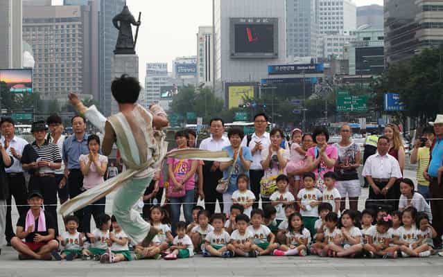 A South Korean Taekwondo expert performs martial arts during an event for tourists in Seoul, South Korea, Wednesday, June 26, 2013. (Photo by Ahn Young-joon/AP Photo)
