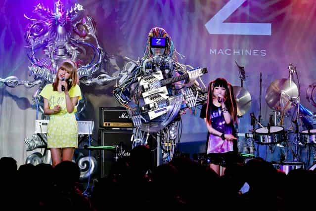 Robot music band Z-Machine perform during their first live event in Tokyo, on June 24, 2013. Supervised by Japanese artists and creators, Z-Machines has been developed to realize the cutting edge party scene by featuring the guitarist robot with 78 fingers and 12 picks, the keyboard robot that can flash multi-layered beams from its eyes and the drummer robot with 21 sticks, enabling transcendental music performance. (Photo by Koji Sasahara/Associated Press)