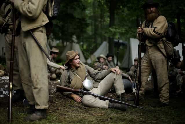 Members of the 1st Tennessee wait to take part in in a demonstration of a battle during ongoing activities commemorating the 150th anniversary of the Battle of Gettysburg, Friday, June 28, 2013, at at Bushey Farm in Gettysburg, Pa. Union forces turned away a Confederate advance in the pivotal battle of the Civil War fought July 1-3, 1863, which was also the war's bloodiest conflict with more than 51,000 casualties. (Photo by Matt Rourke/AP Photo)