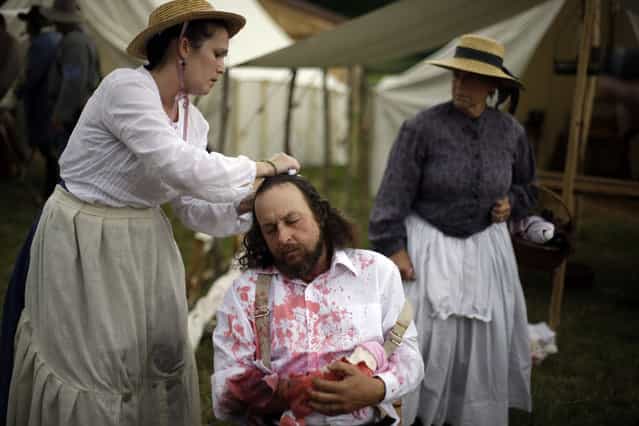 A Floridian portraying a wounded soldier from the 1st N.C. Infantry takes part of demonstration of a Confederate field hospital during ongoing activities commemorating the 150th anniversary of the Battle of Gettysburg, Friday, June 28, 2013, at the Daniel Lady Farm in Gettysburg, Pa. Union forces turned away a Confederate advance in the pivotal battle of the Civil War fought July 1-3, 1863, which was also the war s bloodiest conflict with more than 51,000 casualties. (Photo by Matt Rourke/AP Photo)