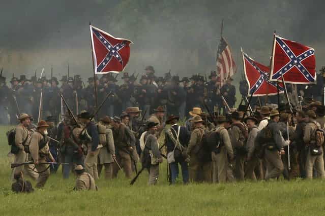 Reenacotrs demonstrate a battle during ongoing activities commemorating the 150th anniversary of the Battle of Gettysburg, Friday, June 28, 2013, at at Bushey Farm in Gettysburg, Pa. Union forces turned away a Confederate advance in the pivotal battle of the Civil War fought July 1-3, 1863, which was also the war s bloodiest conflict with more than 51,000 casualties. (Photo by Matt Rourke/AP Photo)