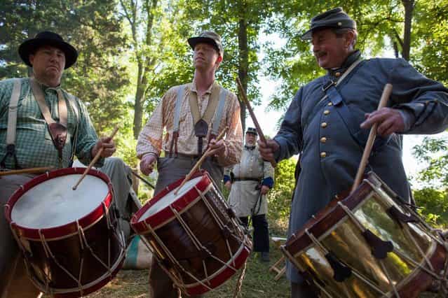 From left, Tommy White, Noah Raper and Jim Smith play drums during the 150th anniversary of the Battle of Gettysburg, Saturday, June 29, 2013, at Bushey Farm in Gettysburg, Pa. The Union Army stopped a major Confederate advance during a battle fought July 1-3, 1863, often considered the war's major turning point. (Photo by Zach Gibson/AP Photo/Richmond Times Dispatch)