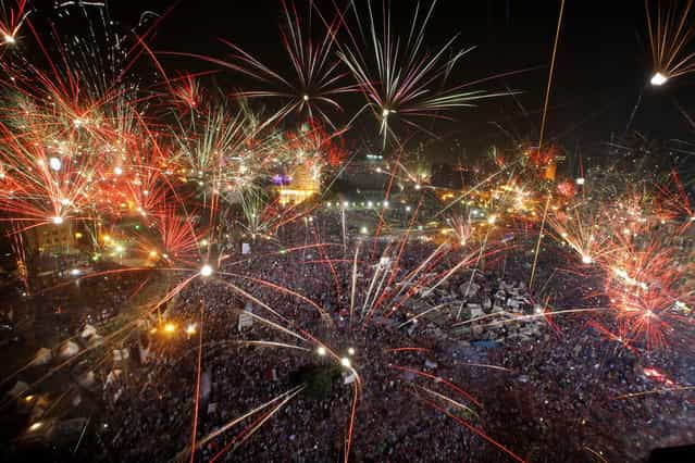 Fireworks light the sky opponents of Egypt's Islamist President Mohammed Morsi celebrate in Tahrir Square in Cairo, Egypt, Wednesday, July 3, 2013. A statement on the Egyptian president's office's Twitter account has quoted Mohammed Morsi as calling military measures [a full coup]. The denouncement was posted shortly after the Egyptian military announced it was ousting Morsi, who was Egypt's first freely elected leader but drew ire with his Islamist leanings. The military says it has replaced him with the chief justice of the Supreme constitutional Court, called for early presidential election and suspended the Islamist-backed constitution.(Photo by Amr Nabil/AP Photo)