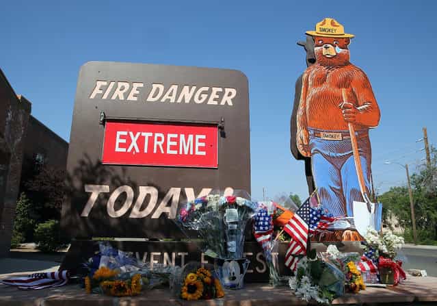 American flags and flowers adorn a [Extreme] fire danger warning outside of Firestation 1 on July 2, 2013 in Prescott, Arizona. Nineteen Granite Mountain Interagency Hotshot Crew firefighters based out of Station 7 died battling a fast-moving wildfire near Yarnell, AZ on Sunday. Station 7 has been the home of the Granite Mountain Interagency Hotshot Crew since 2010. GMIHC is a national resource that responds to wildland and all risk incidents in the Prescott Basin. (Photo by Christian Petersen/Getty Images)