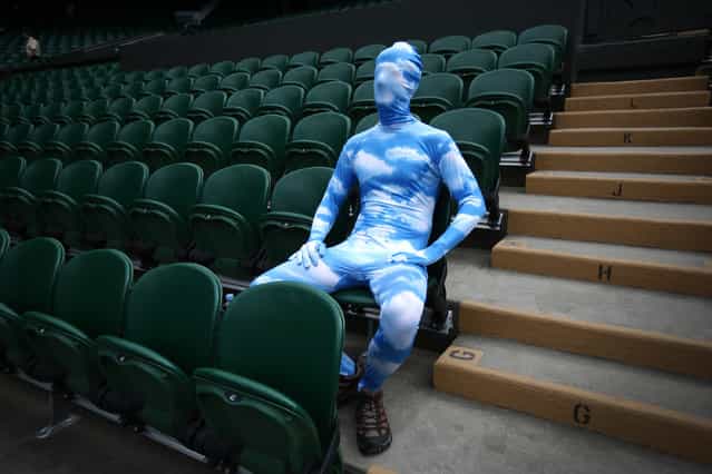 Tennis fan Chris Fava wears a blue sky body suit as he waits for the start of play on Centre Court on day seven of the Wimbledon Lawn Tennis Championships, on July 1, 2013. (Photo by Peter Macdiarmid/Getty Images)